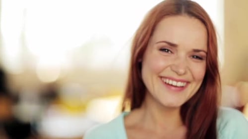 Beautiful Redhead Woman Smiling in Soft Indoor Light