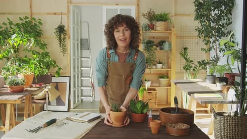 Female Botanist Talking on Camera while Filming Video about Home Garden