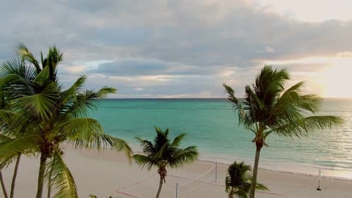 Tropical lagoon at sunset, sunrise, paradise scene with palm trees and crystal clear turquoise color