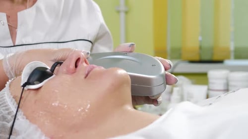 Woman Receiving Laser Skin Treatment in Clinic