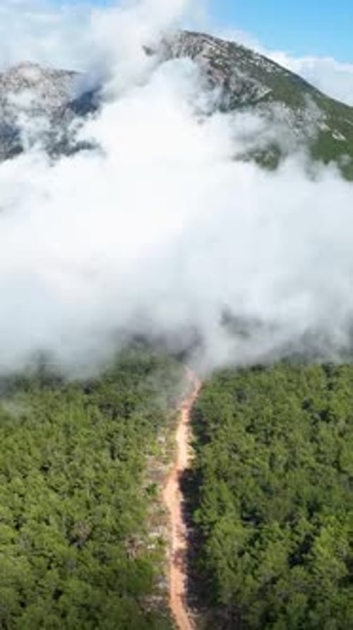 Vertical Video Captivating Mountain Vista Clouds Embracing Nature's Majesty