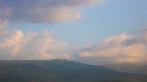 Time-lapse of clouds on the sky over a mountain.