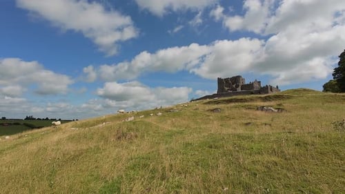 Ireland Epic locations dramatic sky over The rock of Cashel with sheep grazing at the foot of the hi