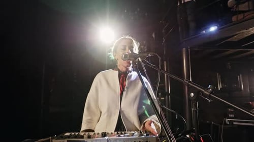 Female Musician Singing and Performing on Stage