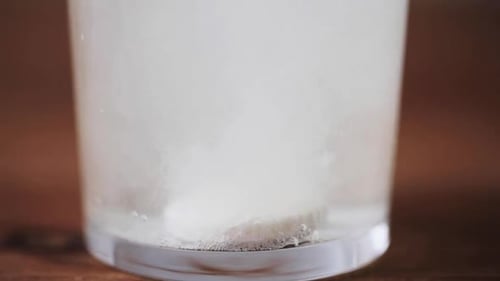 Effervescent tablet dissolves in glass of water