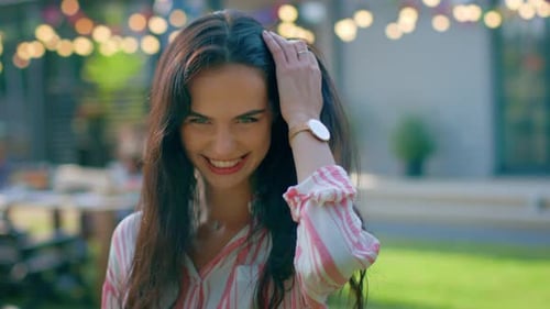 Happy young woman smiling and posing outdoors