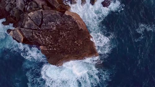 Sharp rocks laying along the coastline of Menorca Spain