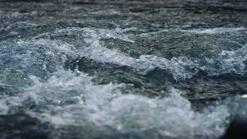Mountain River Water Flowing in . Closeup of Abundant Stream Of