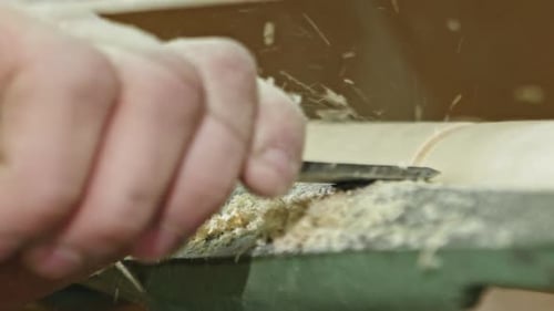 Hands Smoothing Rotating Wood with Tool