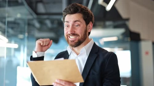 Excited Businessman Celebrates Good News in Office