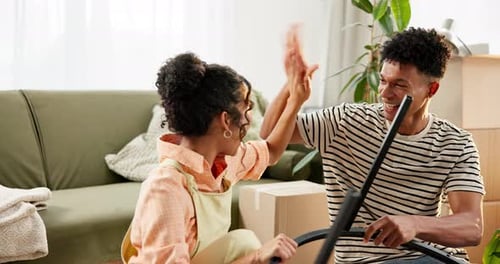 Couple Assembling Furniture Together in New Home