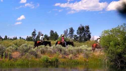 Group Of People Ride Horses By Gorgeous Mountainside Trail 2