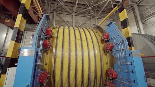 Industrial Machinery Featuring a Large Rotating Drum Installed in a Warehouse Facility Stock Clip