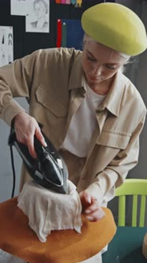 Milliner Pressing Hat in Studio