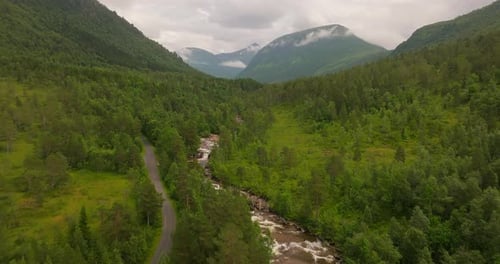 Aerial View Of Road, River, Forest And Mountain Range In West Coast, Norway.