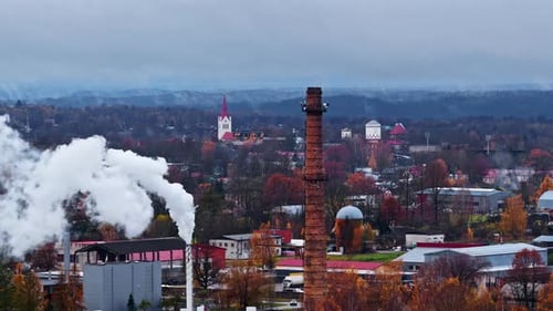 Autumn Townscape with Industrial Smokestack and Cloudy Skies