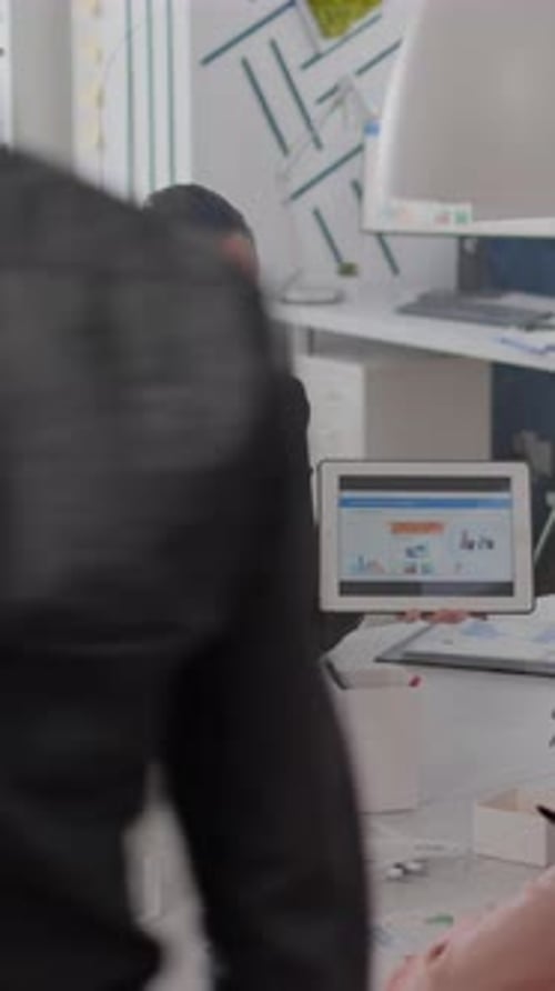 Businesswoman Presents Data on Tablet During Conference Call