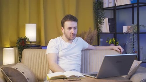 Young Adult Working on Laptop in Living Room