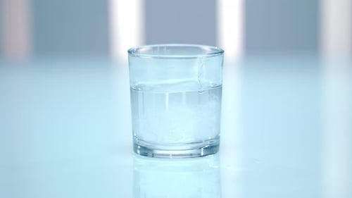 Effervescent Tablet Dissolving in Glass of Water