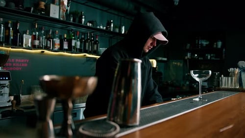 Bartender Working in a Dimly Lit Bar at Night