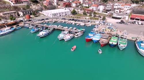 Colorful Fishing Boats Docked At A Peaceful Coastal Harbor Village