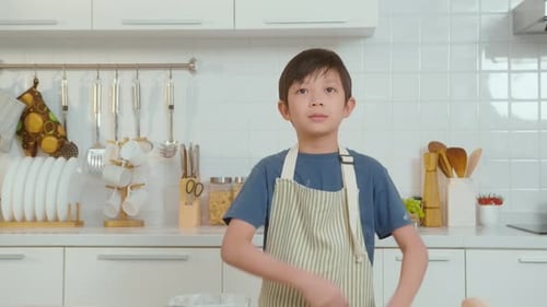 Smiling Boy in Kitchen Wearing Apron