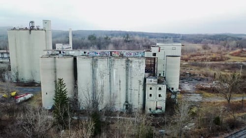 Circling abandoned industrial buildings. (Aerial view)