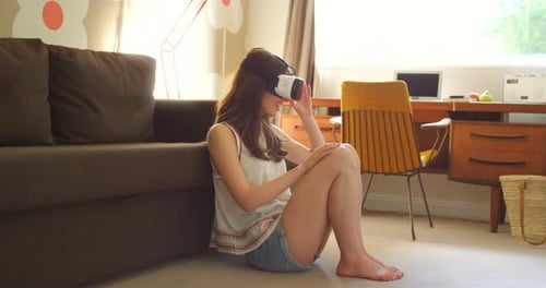 Vr, video gaming and woman on technology in living room floor with 3d virtual reality goggles