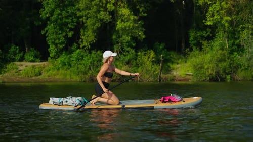 Athletic Woman Practicing Standup Paddle Boarding Sport Lady Floating On Board In River In Summer