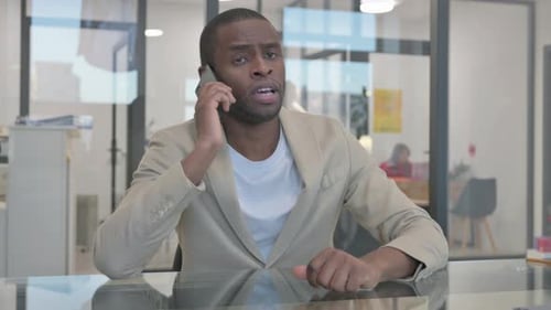Professional Man Talking on Smartphone in Office