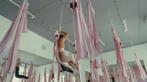 Fit women doing yoga at fly yoga studio