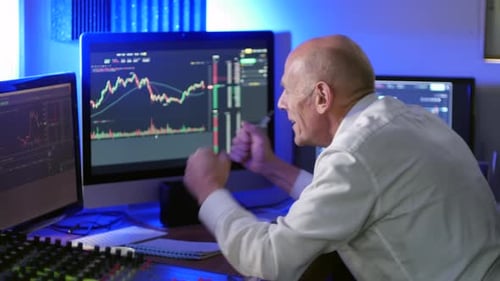 Mature Man Trading Stocks in Office Setting