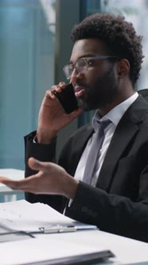 Man in Suit Talking on Smartphone in Office