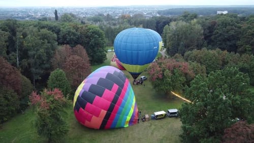 Hot Air Balloons Prepared for Flight in Field