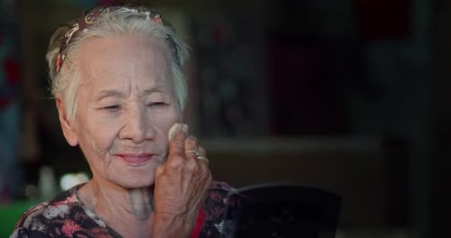 Senior Woman Applying Makeup for Skincare Routine