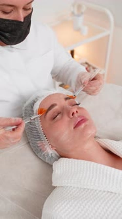 Beautician Applies Facial Treatment