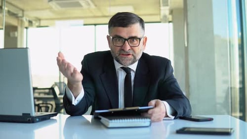 Upset Man Arguing in Office Meeting