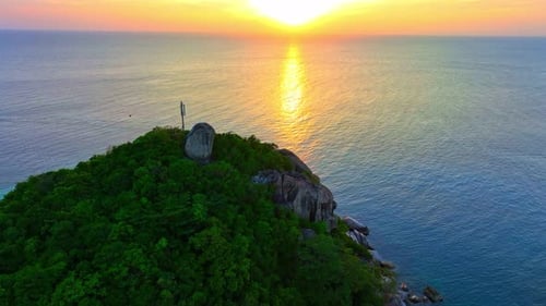 Coastline of tropical island during beautiful sunset from drone view.
