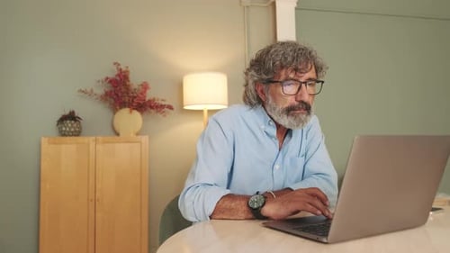 Man Working on Laptop Computer at Home