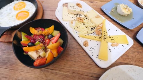 Breakfast food, eggs, cheese, and fruit from above