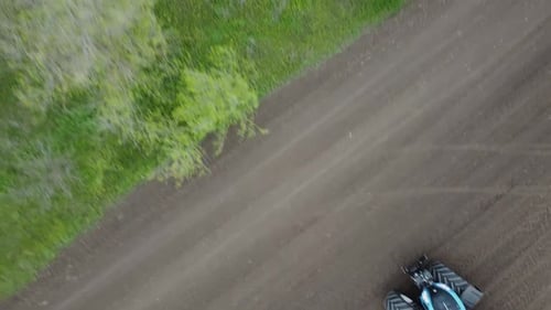 Blue tractor OA working on the field in Ukraine