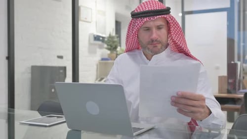Adult Working on Laptop at Desk