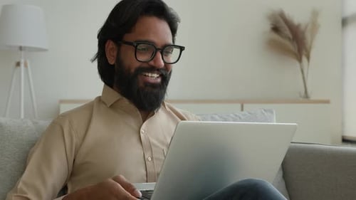 Man Chatting on Laptop Video Call at Home