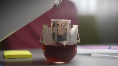 Water Poured into Drip Coffee Filter on Glass
