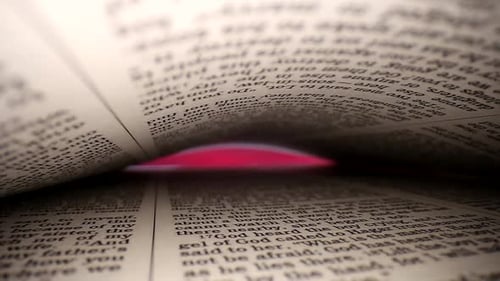 Slowly pushing lens into a book, diagonal view of the pages. Words eye view of the pages, on both to