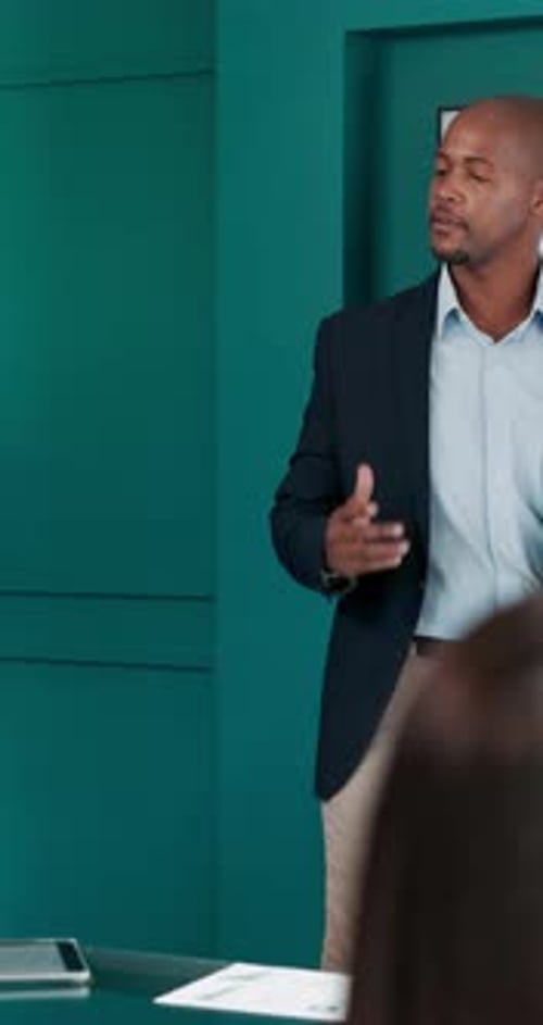 Man Presenting Data in Modern Business Office