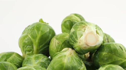 Brussels sprouts rotate on a white background.