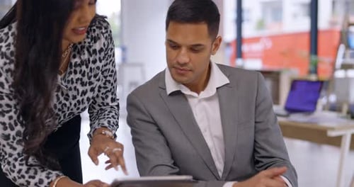 Coworkers Discussing Data on Tablet in Office