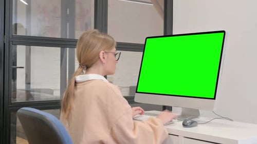 Young Woman Using Desktop with Green Screen