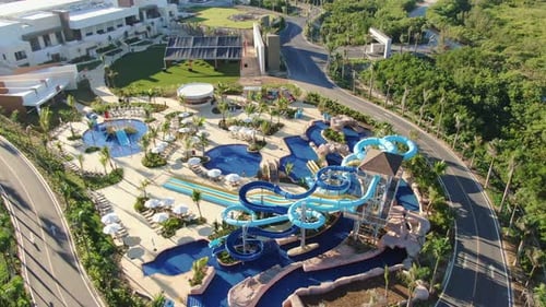 Aerial view of tropical resort with adventure waterpark, aquapark, water slides and swimming pool ar